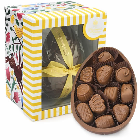 Large Charbonnel et Walker Milk Chocolate Easter Egg in a yellow box with a yellow bow and half an egg filled with milk chocolates.