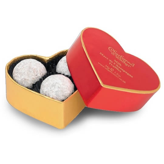 A red and gold heart shaped chocolate box with milk chocolate Marc de Champagne truffles inside.