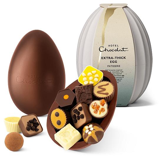 Hotel Chocolat Patisserie Chocolate Extra Thick Easter Egg, dark and milk chocolate shell with chocolates on display.